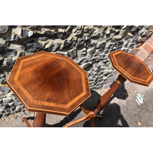 143 - A pair of Edwardian mahogany torcheres, in the Georgian style, the octagonal tops with flame veneer,... 