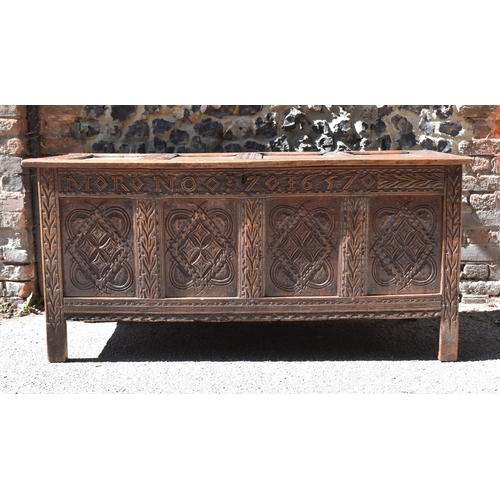 149 - A late 17th century oak coffer, with four carved panel top and foliate carved four panel front on st... 