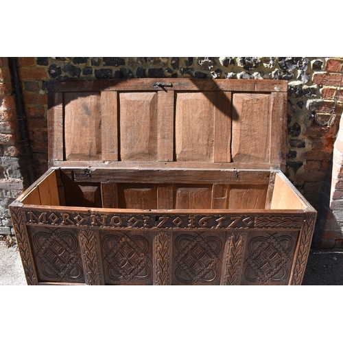 149 - A late 17th century oak coffer, with four carved panel top and foliate carved four panel front on st... 