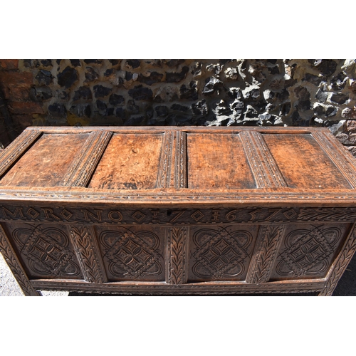 149 - A late 17th century oak coffer, with four carved panel top and foliate carved four panel front on st... 