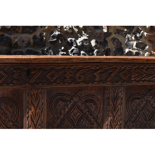 149 - A late 17th century oak coffer, with four carved panel top and foliate carved four panel front on st... 