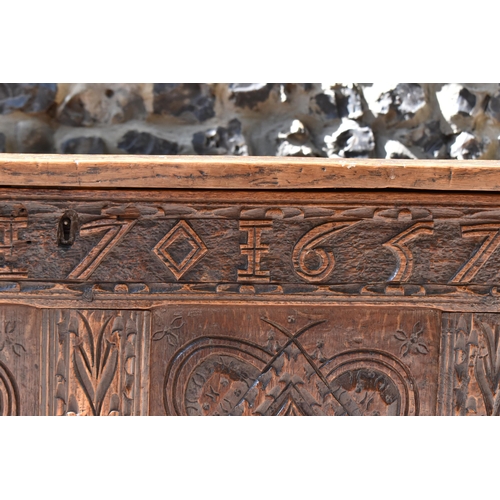 149 - A late 17th century oak coffer, with four carved panel top and foliate carved four panel front on st... 