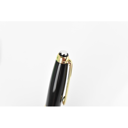 72 - A Montblanc Meisterstuck Pix rollerball pen, in black lacquer and gilt, the tip of the cap with engr... 