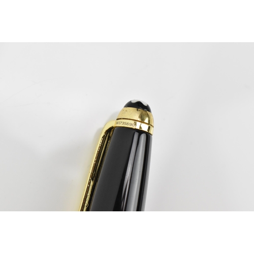 72 - A Montblanc Meisterstuck Pix rollerball pen, in black lacquer and gilt, the tip of the cap with engr... 