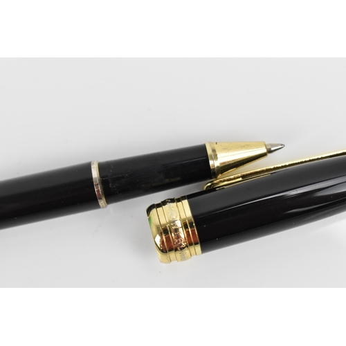 72 - A Montblanc Meisterstuck Pix rollerball pen, in black lacquer and gilt, the tip of the cap with engr... 