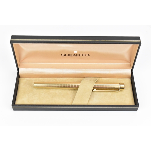 73 - A Sheaffer gold-plated fountain pen, with 14ct yellow gold nib, stamped 585, of tapered form with pa... 