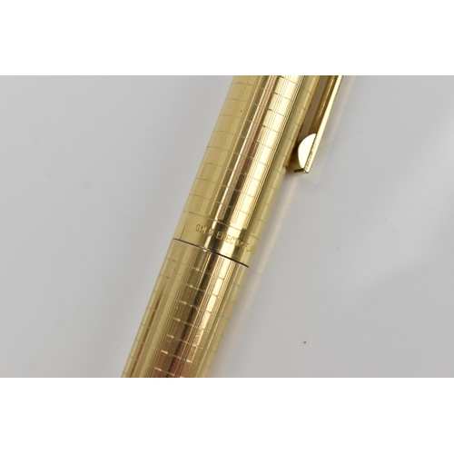 73 - A Sheaffer gold-plated fountain pen, with 14ct yellow gold nib, stamped 585, of tapered form with pa... 