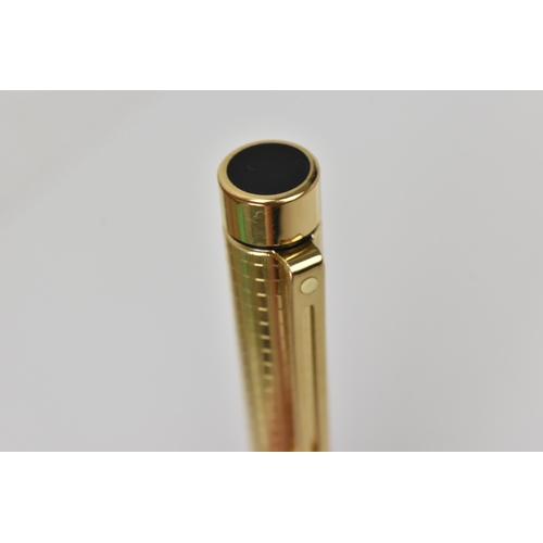 73 - A Sheaffer gold-plated fountain pen, with 14ct yellow gold nib, stamped 585, of tapered form with pa... 