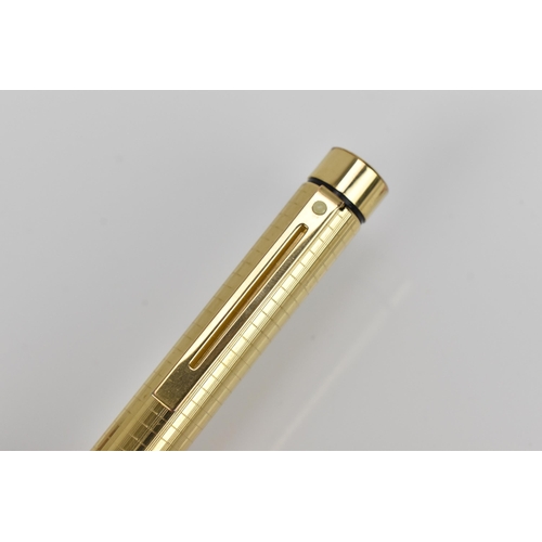 73 - A Sheaffer gold-plated fountain pen, with 14ct yellow gold nib, stamped 585, of tapered form with pa... 