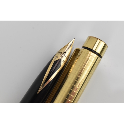 73 - A Sheaffer gold-plated fountain pen, with 14ct yellow gold nib, stamped 585, of tapered form with pa... 