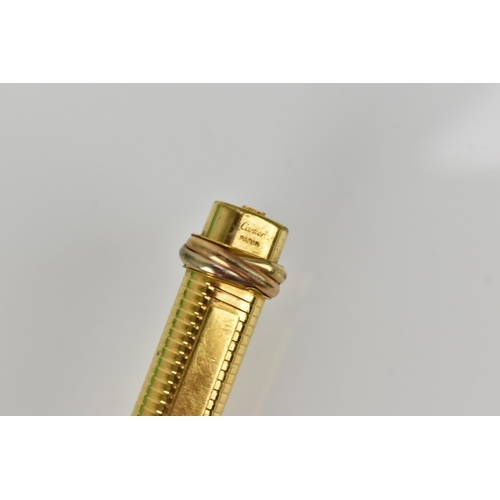 75 - A Must de Cartier gold plated ballpoint pen with push button to lid bringing the clip out
Location: ... 