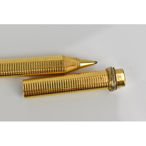 75 - A Must de Cartier gold plated ballpoint pen with push button to lid bringing the clip out
Location: ... 