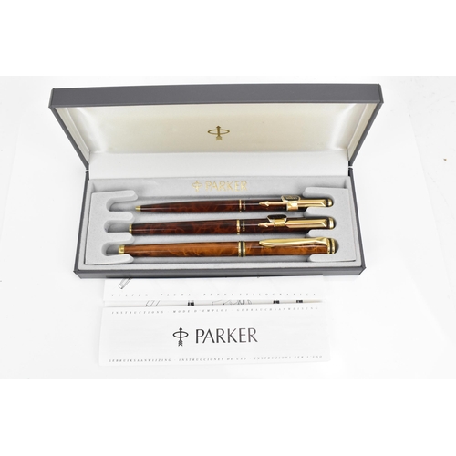 83 - A cased set of Chinese lacquer Parker pens, comprising two fountain and one ballpoint pen, each with... 