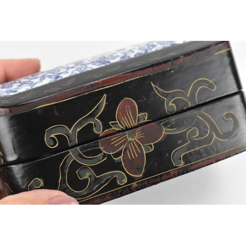 100 - Two Oriental lacquer boxes, each mounted with Chinese blue and white porcelain pieces to the lids, t... 