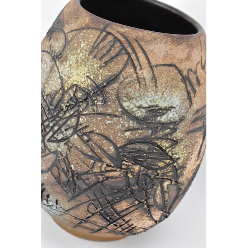 103 - A Japanese sgraffito stoneware vase, of ovoid form with deep sgraffito striations, shapes and curves... 