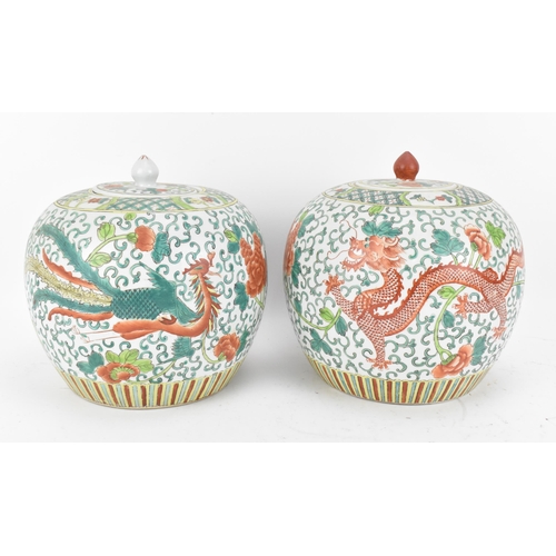 104 - A pair of Chinese Famille Verte porcelain ginger jars, early 20th century, of ovoid form with dragon... 