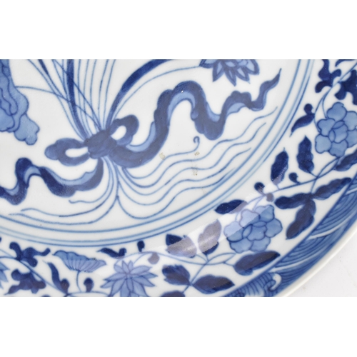 94 - A Chinese blue and white porcelain dish, Qing dynasty style, of circular form, with underglazed blue... 