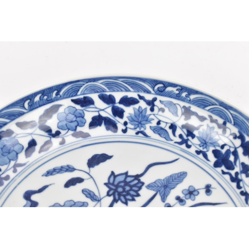 94 - A Chinese blue and white porcelain dish, Qing dynasty style, of circular form, with underglazed blue... 