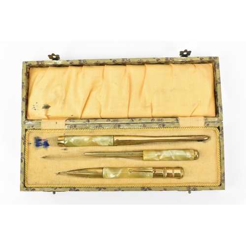 82 - An early 20th century Art Deco cased desk set, in marbled bakelite and gold coloured metal, comprisi... 