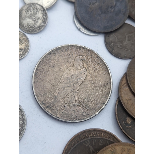 64 - A mixed collection of world coins to include a 1924 'Eagle' Dollar and later USA coins to include 19... 