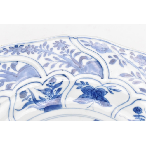 107 - A Chinese blue and white porcelain charger, early 18th century, Kangxi period, with central naturali... 