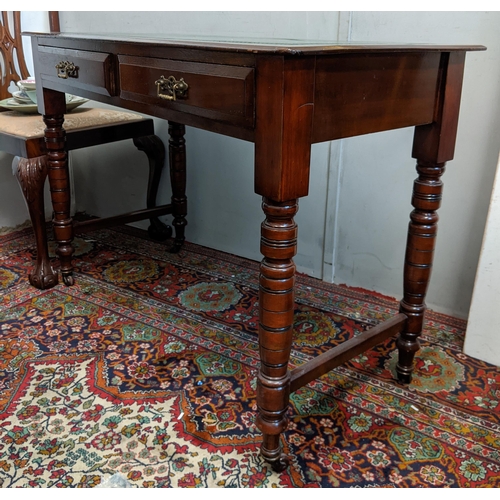 316 - An early 20th century mahogany desk with a green leather topped scriber with side stretchers, raised... 