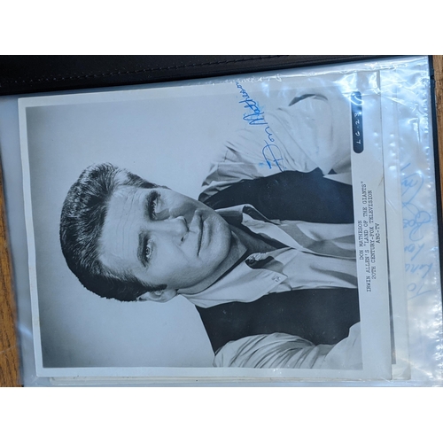 320 - A folder of signed postcards, photographs and photographic prints to include John Travolta, Bert Wee... 