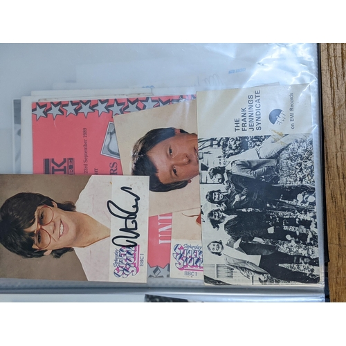 320 - A folder of signed postcards, photographs and photographic prints to include John Travolta, Bert Wee... 