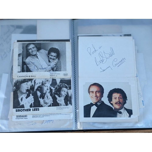 320 - A folder of signed postcards, photographs and photographic prints to include John Travolta, Bert Wee... 