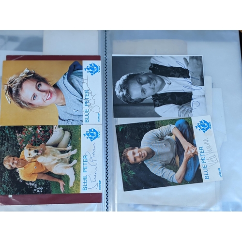 320 - A folder of signed postcards, photographs and photographic prints to include John Travolta, Bert Wee... 