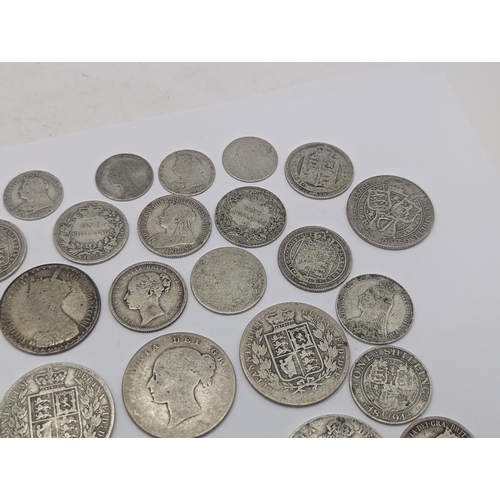 44 - A collection of British Victorian silver coins to include 12 half crowns, 5 'Gothic' florins 1899 an... 