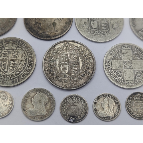 44 - A collection of British Victorian silver coins to include 12 half crowns, 5 'Gothic' florins 1899 an... 