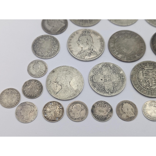 44 - A collection of British Victorian silver coins to include 12 half crowns, 5 'Gothic' florins 1899 an... 