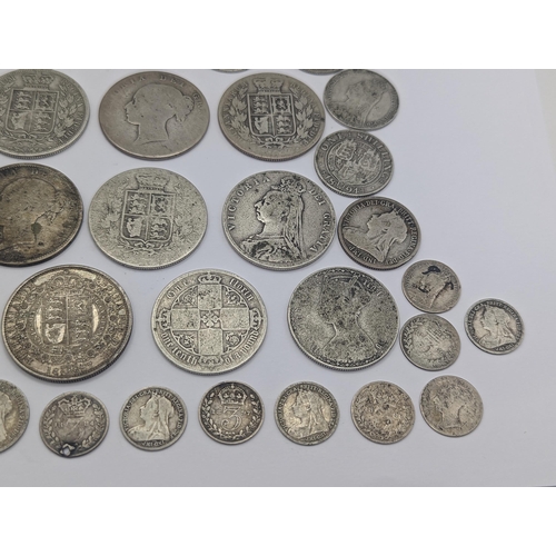 44 - A collection of British Victorian silver coins to include 12 half crowns, 5 'Gothic' florins 1899 an... 