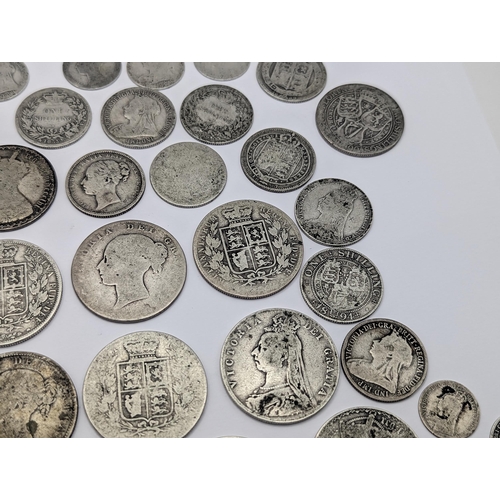 44 - A collection of British Victorian silver coins to include 12 half crowns, 5 'Gothic' florins 1899 an... 