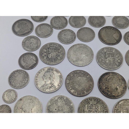 44 - A collection of British Victorian silver coins to include 12 half crowns, 5 'Gothic' florins 1899 an... 