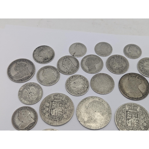 44 - A collection of British Victorian silver coins to include 12 half crowns, 5 'Gothic' florins 1899 an... 