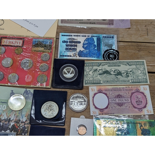 96 - A collection of world coinage to include UK Proof coin sets, 1971, 1977, 1996, 2005 and others, alon... 