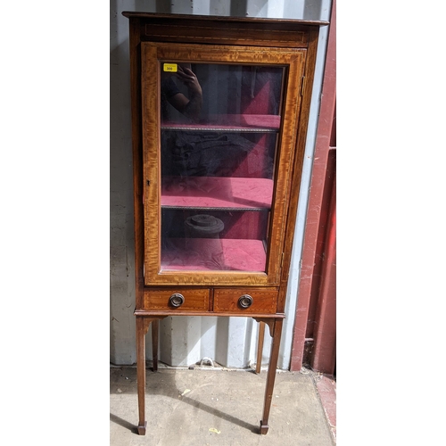 300 - An Edwardian mahogany display cabinet having a single glazed door above two drawers, 156cm h x 57cm ... 