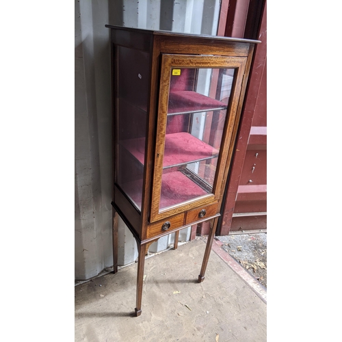 300 - An Edwardian mahogany display cabinet having a single glazed door above two drawers, 156cm h x 57cm ... 