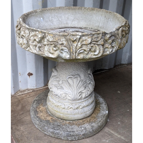 305 - A large reconstituted stoneware garden planter decorated in relief and raised on a circular base, 76... 