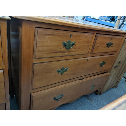 121 - Early 20th century pine chest of two short and two long drawers on short turned legs and castors 82c... 