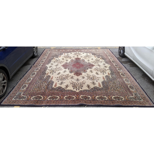 307 - A large machine woven Persian design carpet having a central medallion, beige, ground an multi guard... 