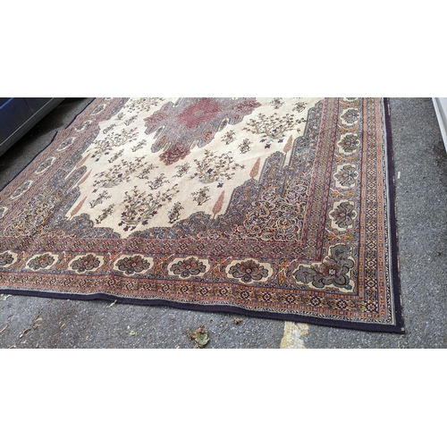 307 - A large machine woven Persian design carpet having a central medallion, beige, ground an multi guard... 