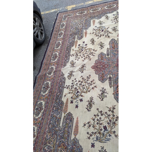 307 - A large machine woven Persian design carpet having a central medallion, beige, ground an multi guard... 