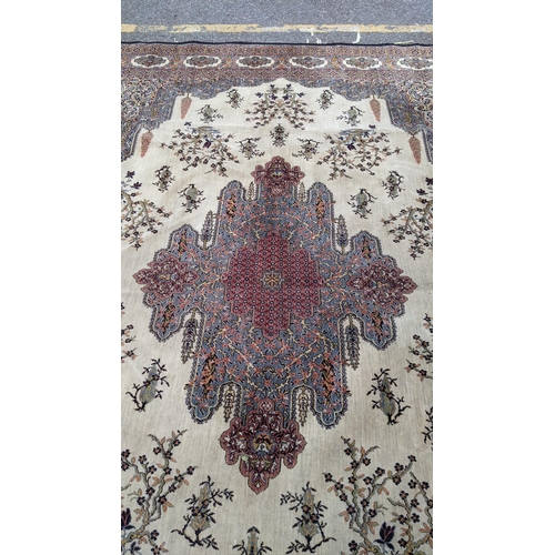 307 - A large machine woven Persian design carpet having a central medallion, beige, ground an multi guard... 