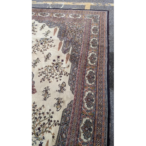 307 - A large machine woven Persian design carpet having a central medallion, beige, ground an multi guard... 