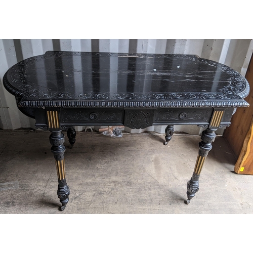 308 - A Victorian ebonized hall table having egg and dart moulded moulded border, carved scroll design and... 