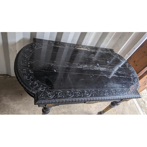 308 - A Victorian ebonized hall table having egg and dart moulded moulded border, carved scroll design and... 