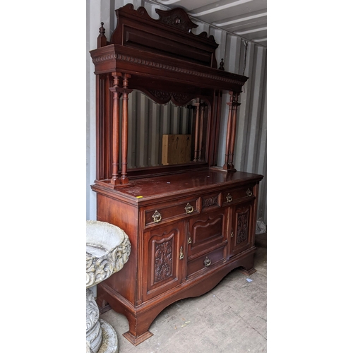 309 - A late Victorian mahogany mirrored back cabinet having a stepped cornice two finials, egg and dart m... 